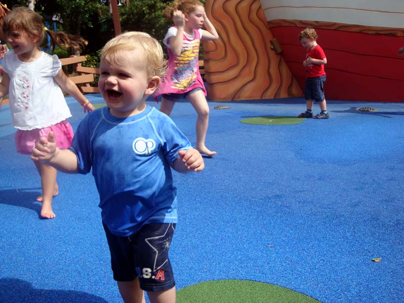 toddler playing at Donalds Boat splash yard in Magic Kingdom