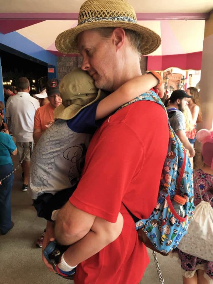 Dad holding toddler at Disney World